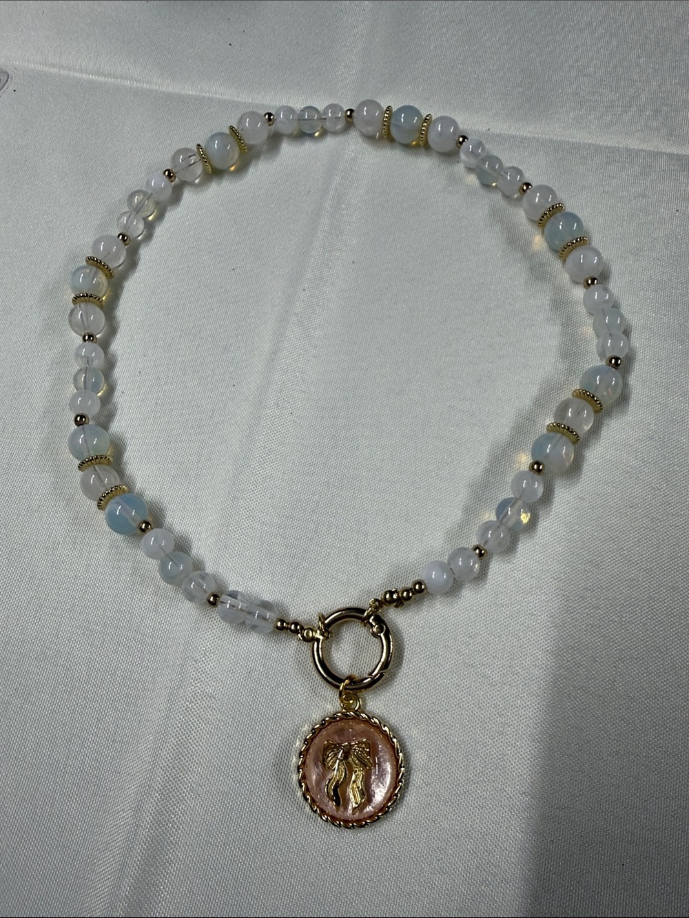 Gold-Accented White Beaded Necklace with Pink Coin Charm